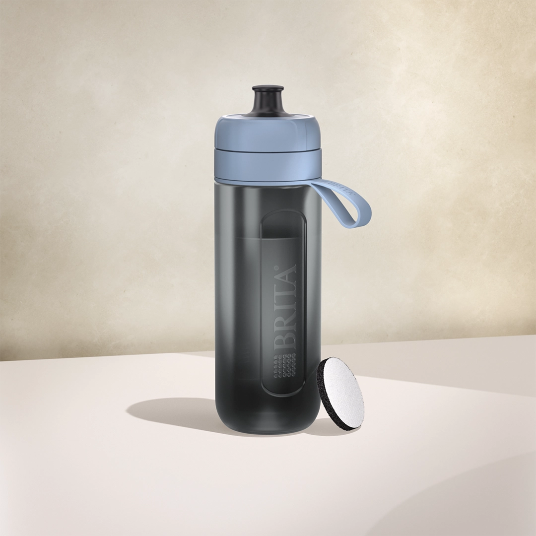 BRITA Active water filter bottle in dark blue on a beige background