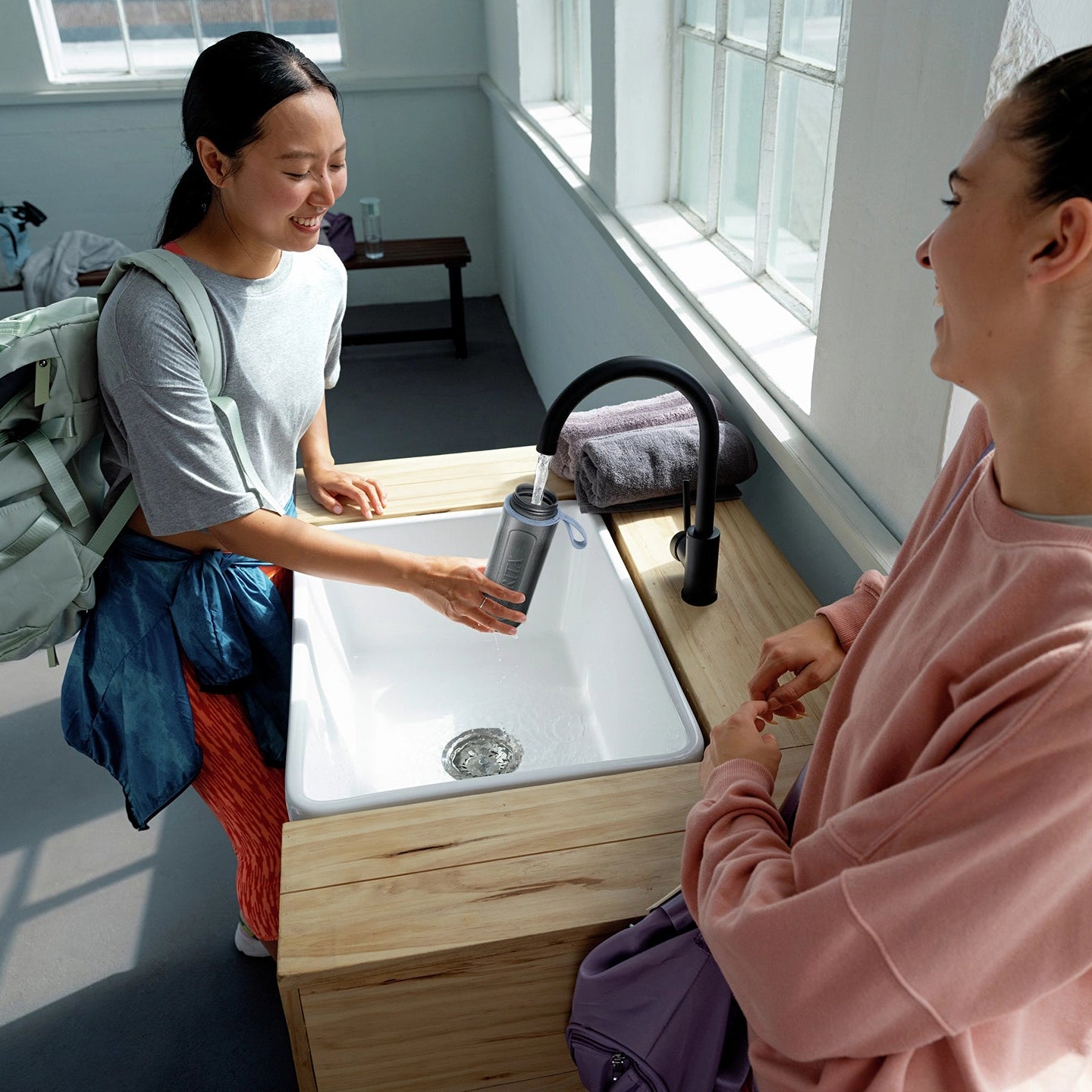 Woman filling BRITA water filter bottle Model Active in gym