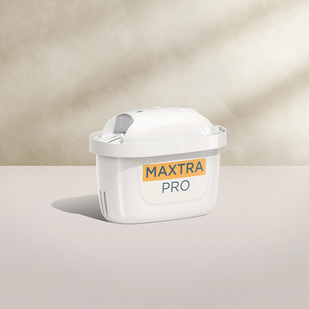 A BRITA MAXTRA PRO LIMESCALE EXPERT water filter cartridge on a beige background