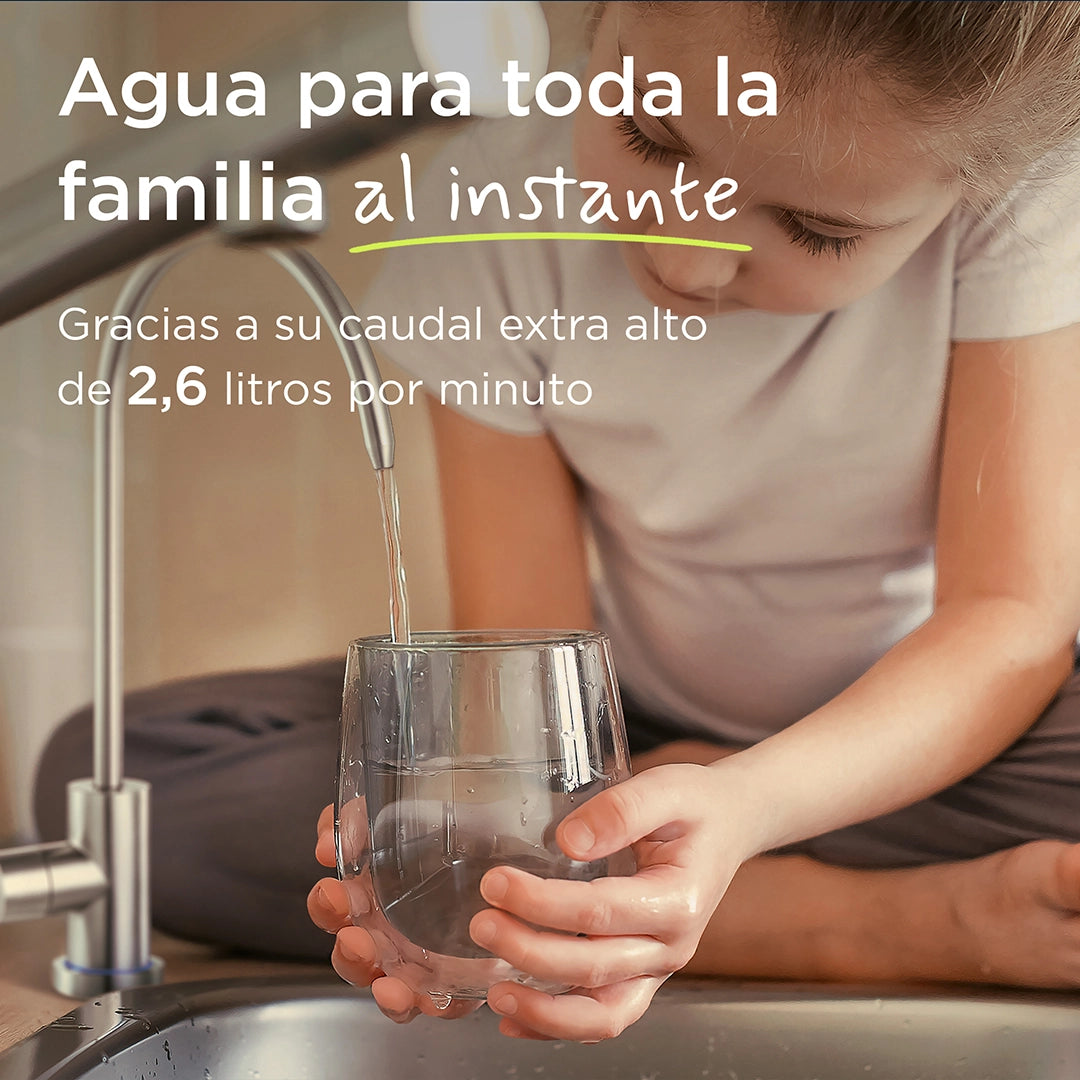 Child filling a drinking glass with filtered water from a kitchen tap