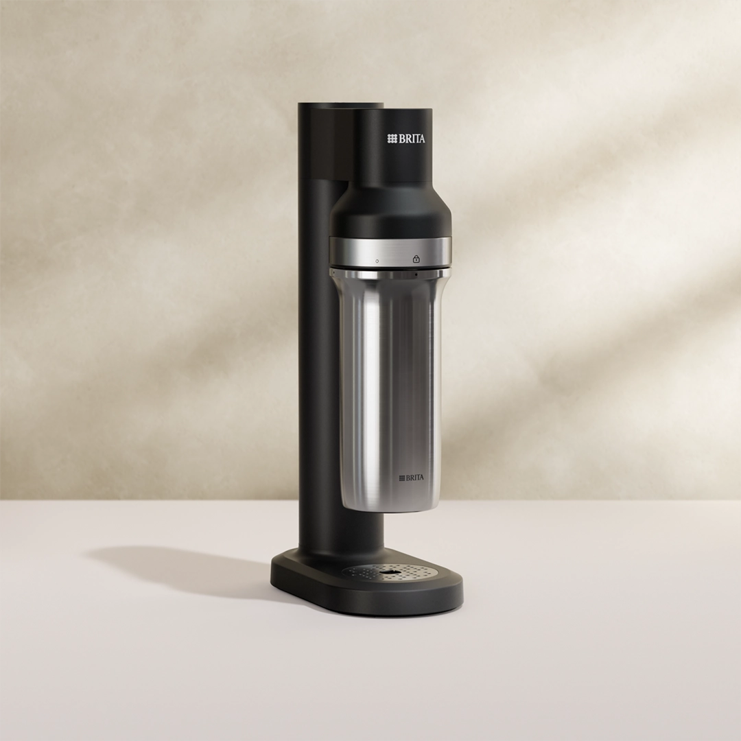 The black BRITA sparkling water maker sodaTRIO on a beige background