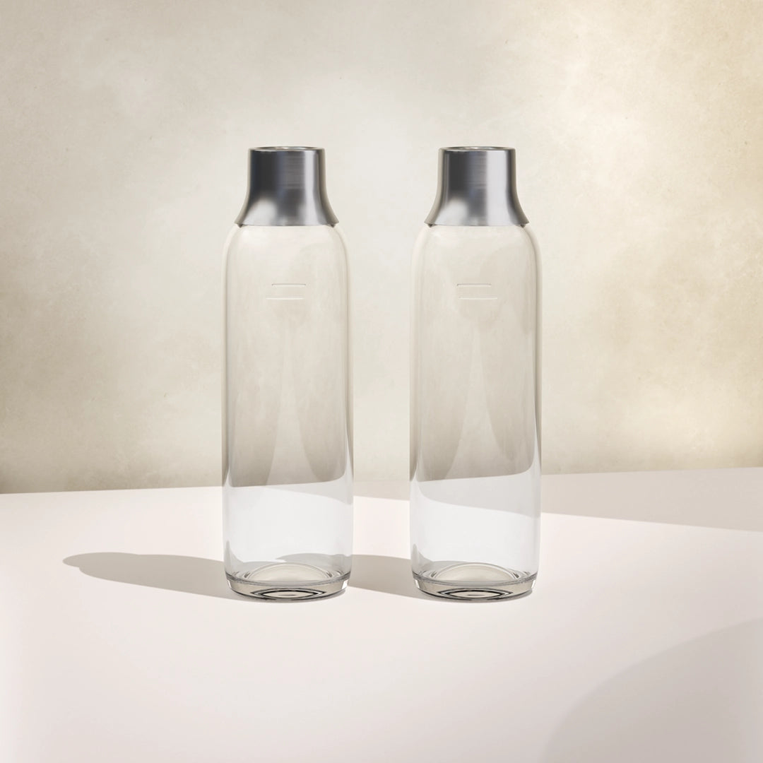 Two BRITA sodaTRIO glass bottles side by side on a white background